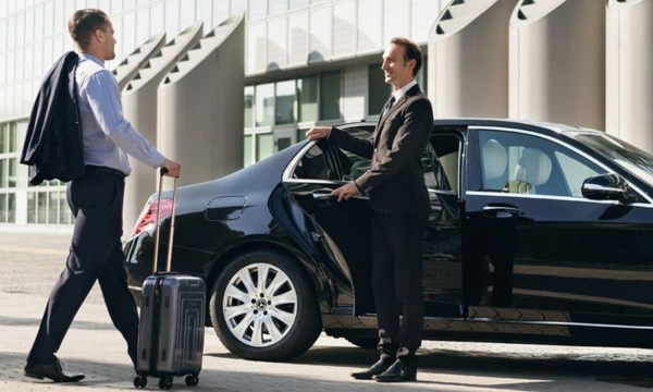 chauffeur opening door for client at the airport